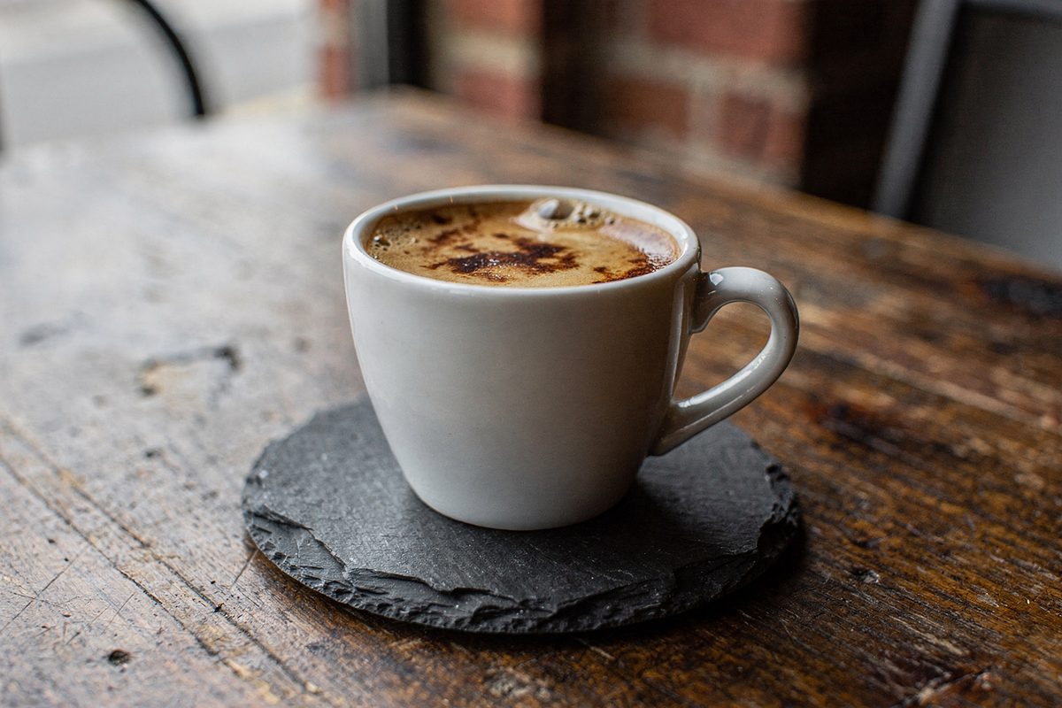 Freshly pulled double espresso with thick crema in a ceramic cup